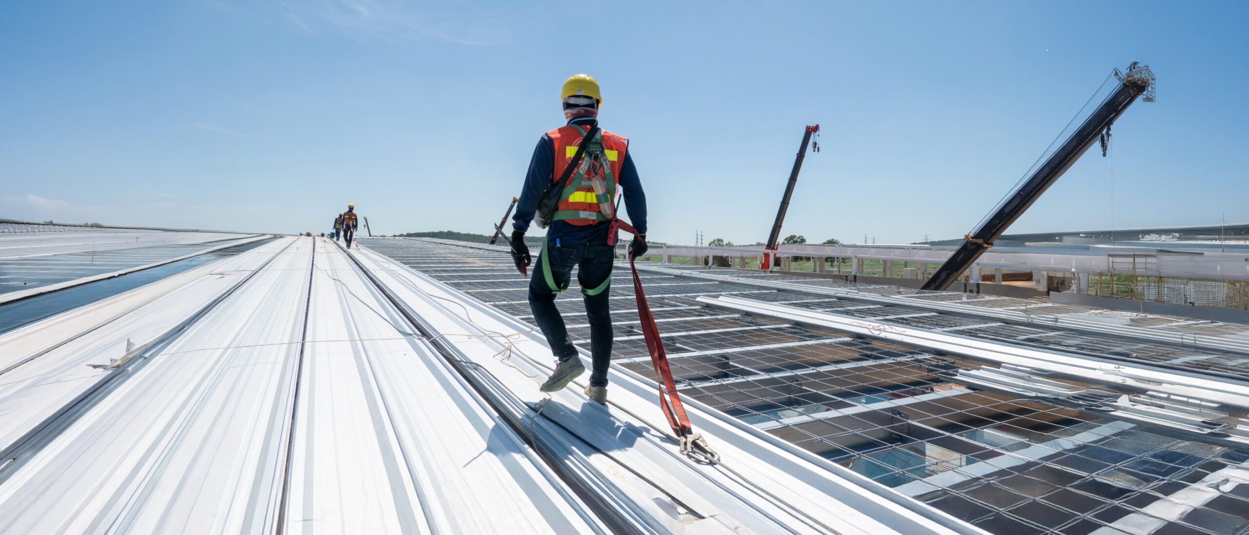 Image of worker working at heights and wearing safety equipment