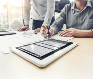 Two people working on with Simpel's tender module on a tablet